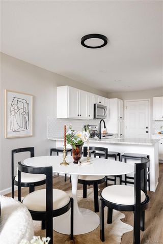 a kitchen with a table and chairs in it