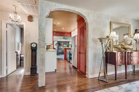 a view of a kitchen with dining area wooden floor and entryway