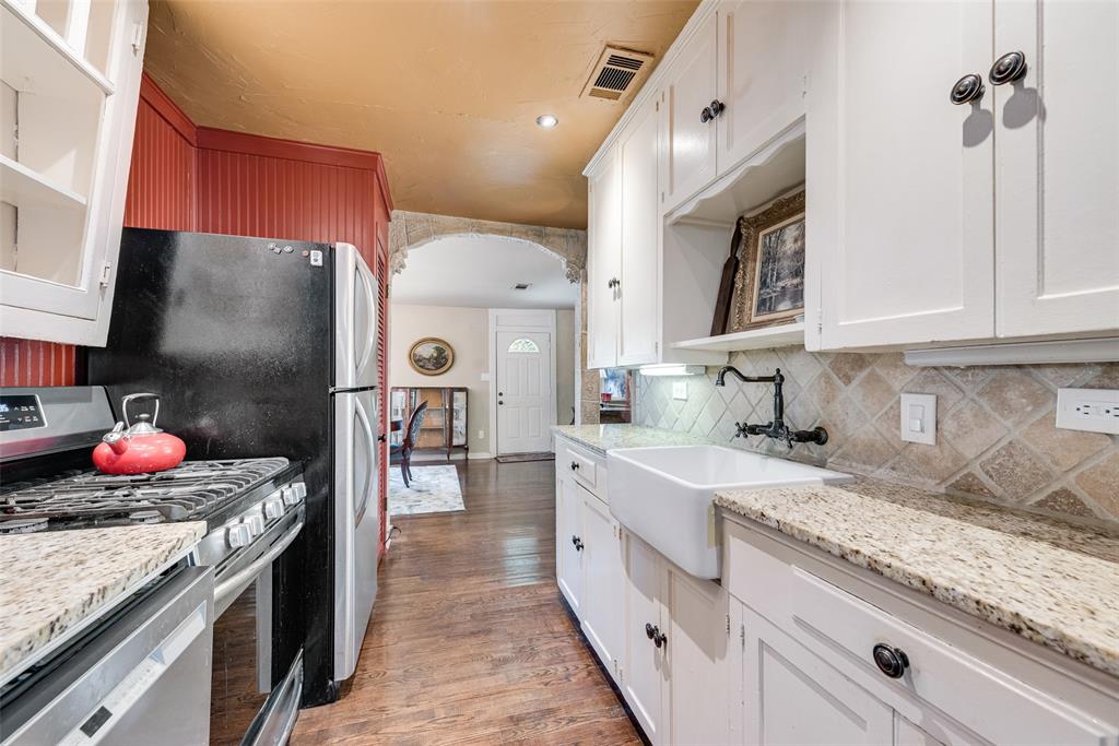 3022 Aster Street Dallas, TX 75211 - Photo 14 of 31 a kitchen with stainless steel appliances granite countertop a sink stove and refrigerator
