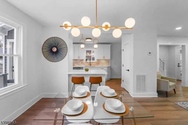 a kitchen with wooden floor and stainless steel appliances