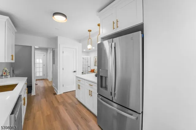 a kitchen with stainless steel appliances a refrigerator sink and cabinets