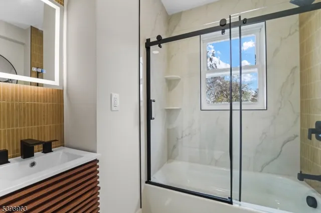 a bathroom with a shower and a sink