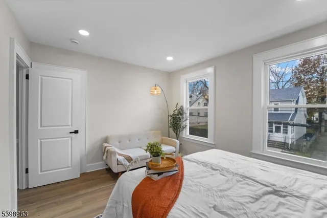 a bedroom with furniture and a wooden floor