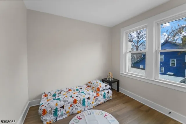 a bedroom with a bed and a painting on the wall