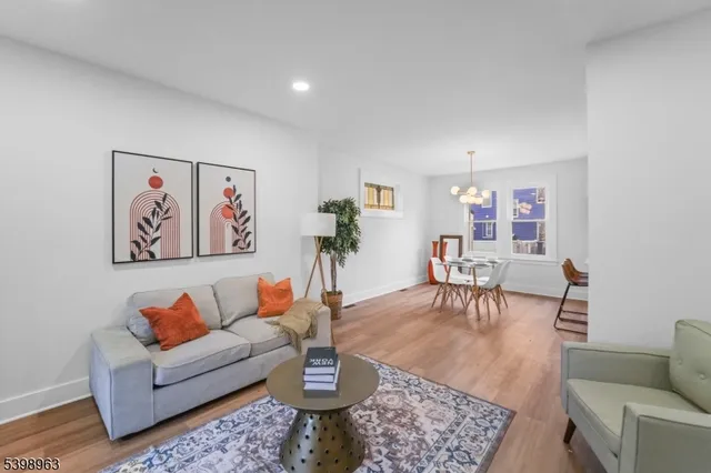 a living room with furniture a rug and a painting on the wall