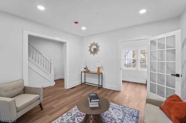 a living room with furniture and a wooden floor