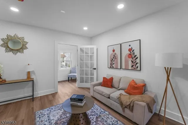 a living room with furniture and wooden floor