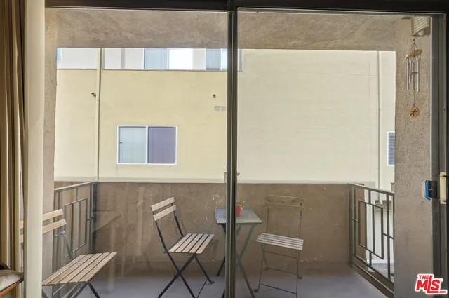 a balcony with table and chairs