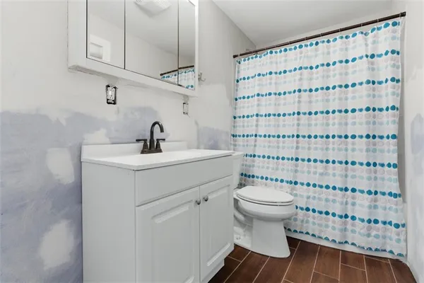 a bathroom with a sink toilet and shower