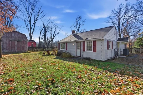 a view of a yard in front of a house with large tree