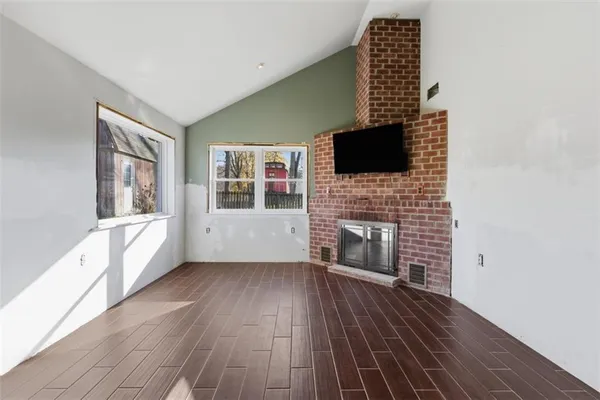 a living room with furniture fireplace and flat screen tv