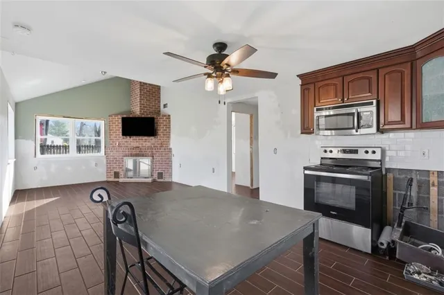a kitchen with kitchen island a stove a sink and a microwave