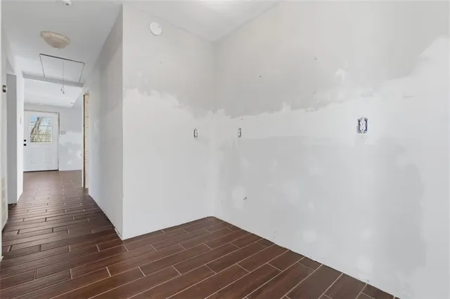 a view of a hallway with wooden floor