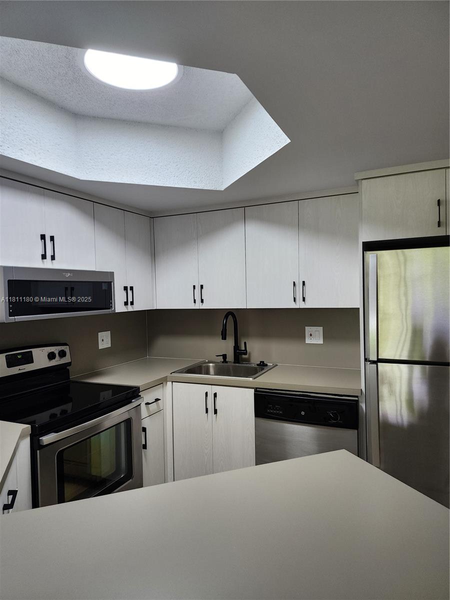 a kitchen with a sink and a stove top oven