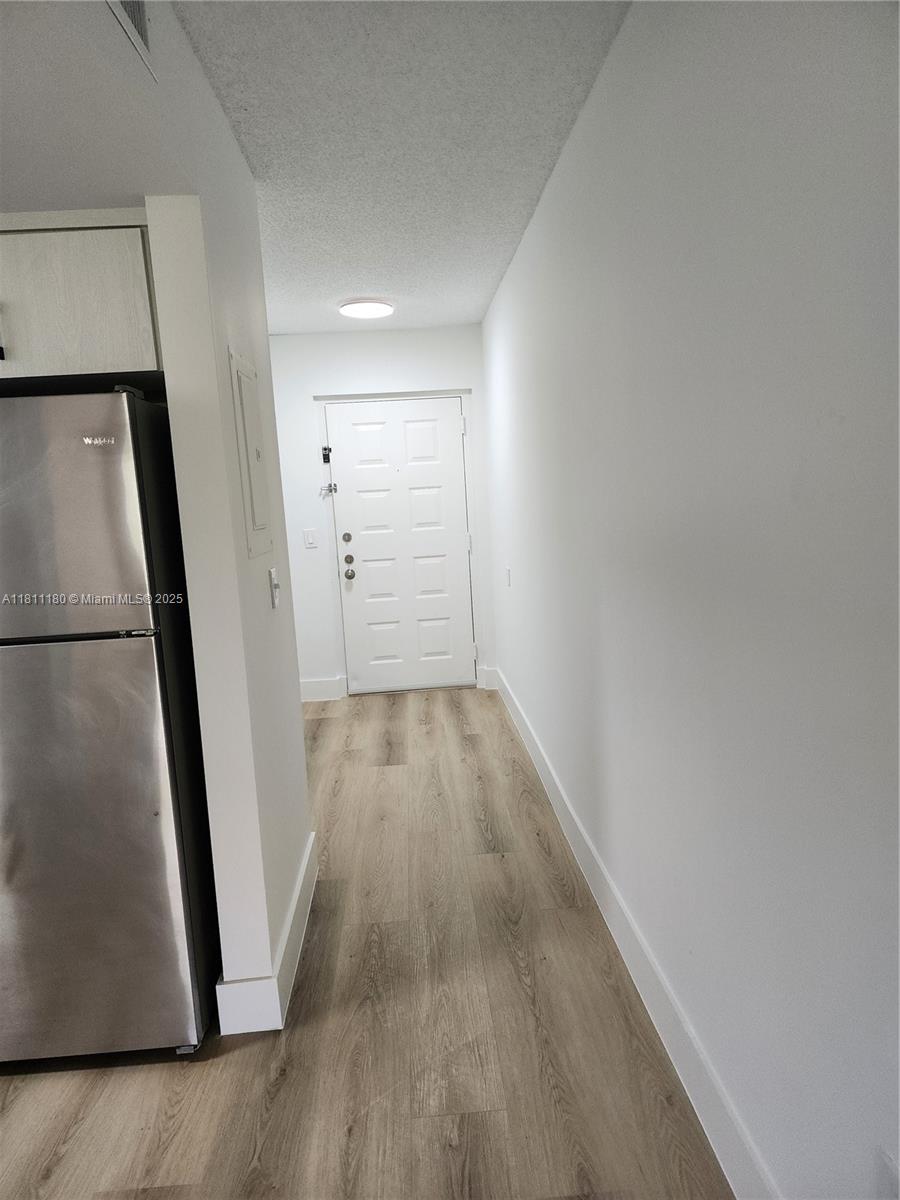 8343 Lake Drive, Unit 403 Doral, FL 33166 - Photo 2 of 8 a view of hallway with wooden floor