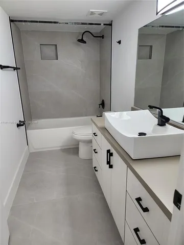 a bathroom with a sink a toilet and a bathtub