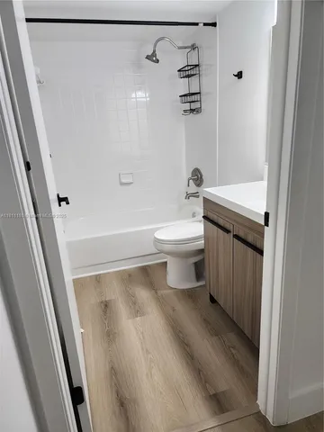 a bathroom with a toilet a sink and shower