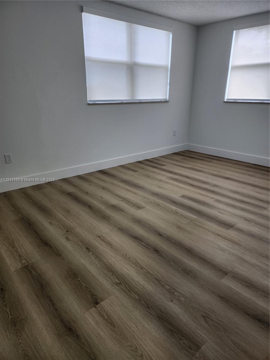 8343 Lake Drive, Unit 403 Doral, FL 33166 - Photo 7 of 8 a view of empty room with wooden floor