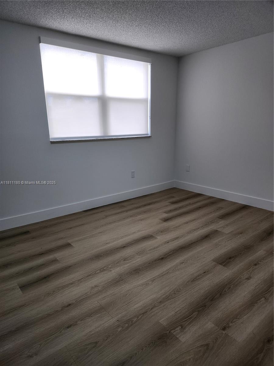 8343 Lake Drive, Unit 403 Doral, FL 33166 - Photo 8 of 8 an empty room with a window