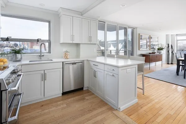 a kitchen with a sink window and cabinets