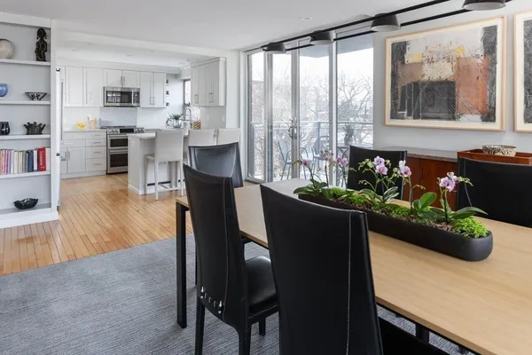 a dining room with furniture and wooden floor