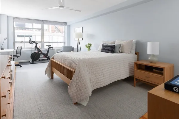 a spacious bedroom with a bed and a couch