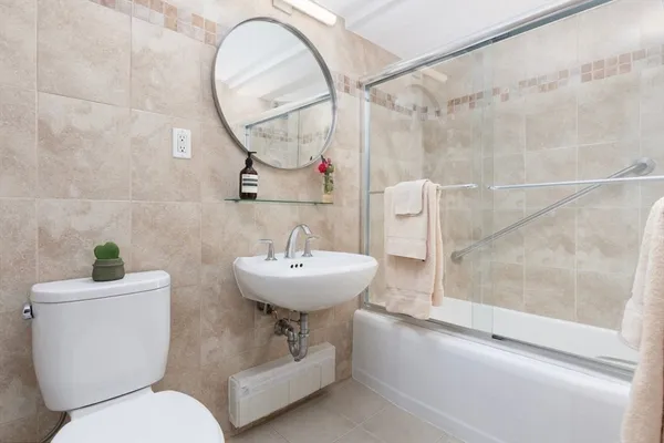 a bathroom with a sink toilet and a mirror