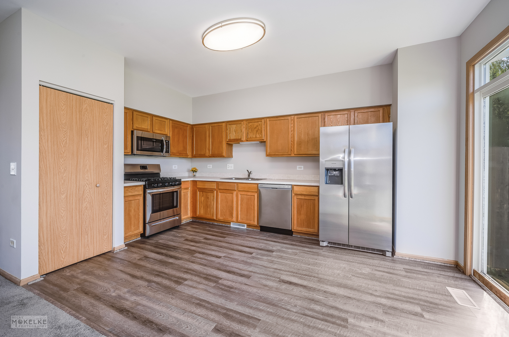 4212 Dillon Street Plano, IL 60545 - Photo 12 of 26 a kitchen with stainless steel appliances granite countertop a refrigerator and a sink