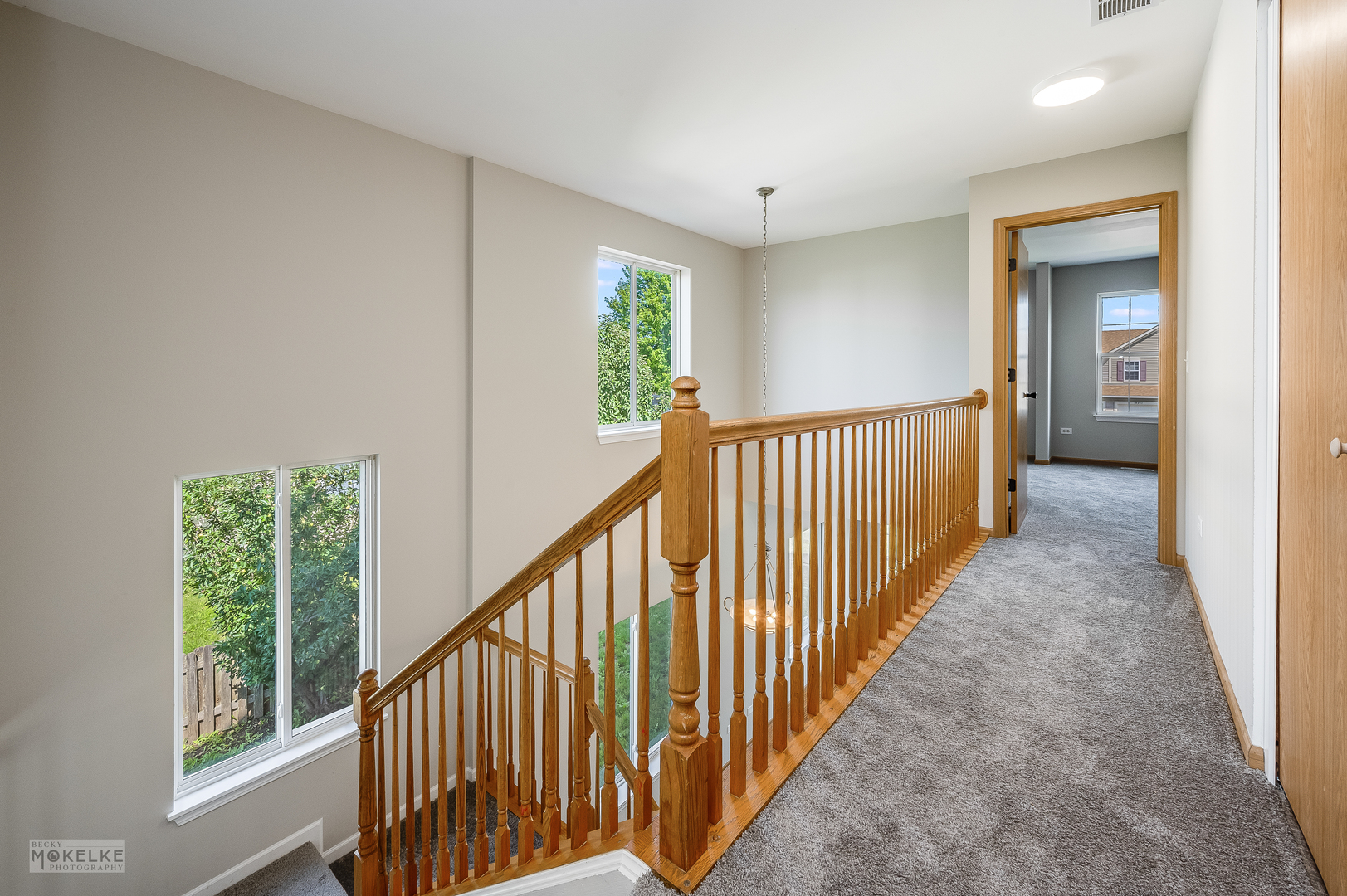 4212 Dillon Street Plano, IL 60545 - Photo 15 of 26 a view of a hallway with wooden floor and stairs