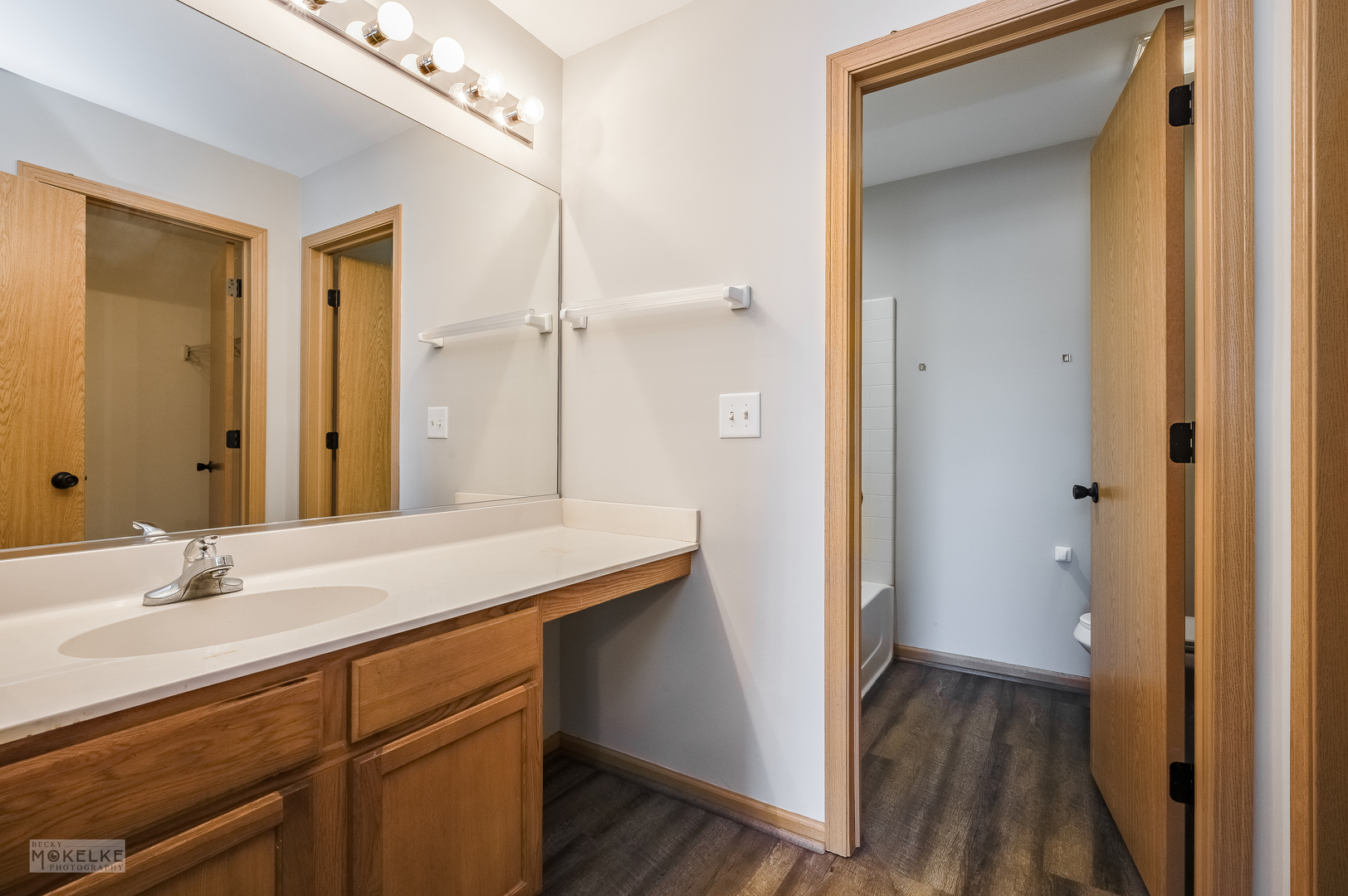 4212 Dillon Street Plano, IL 60545 - Photo 18 of 26 a bathroom with a sink a mirror and a shower