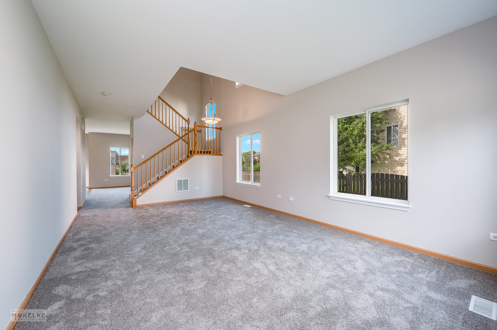 4212 Dillon Street Plano, IL 60545 - Photo 8 of 26 an empty room with windows and stairs