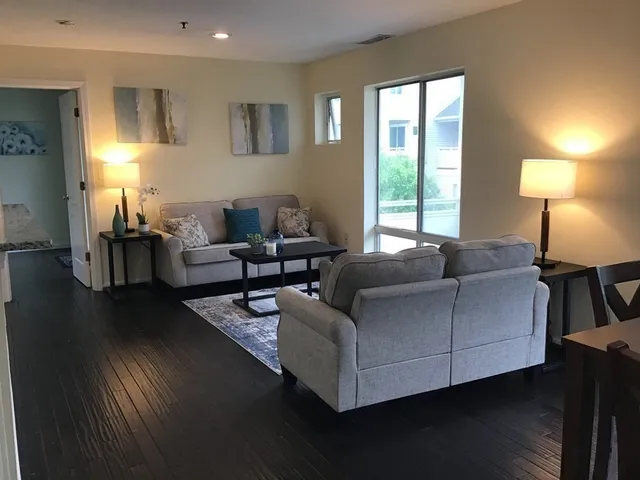 a living room with furniture and a lamp