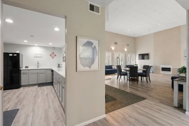 a kitchen with furniture and a wooden floor