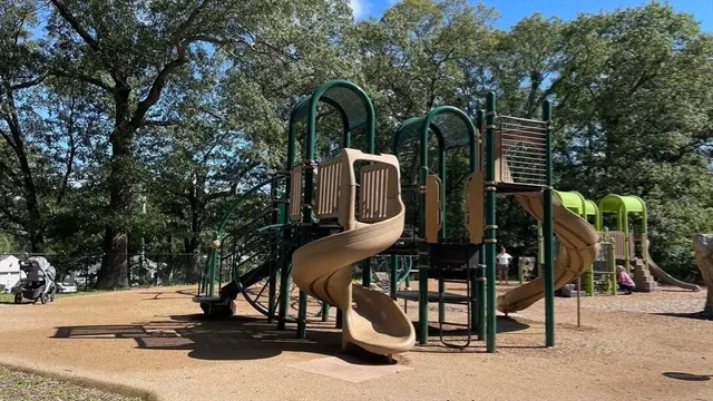a view of a park with iron fence