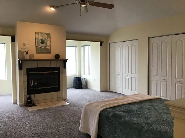 a bedroom with a bed and a fireplace