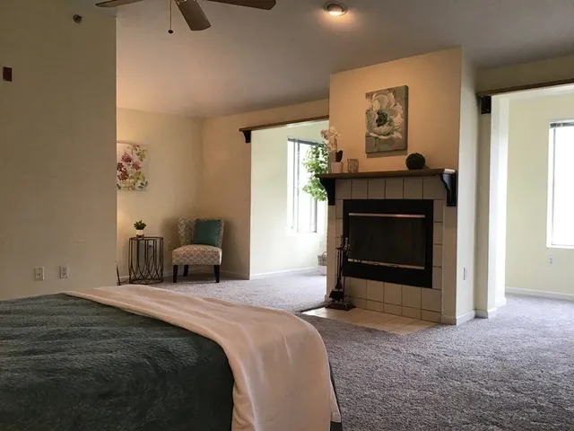 a bedroom with a bed and a fireplace