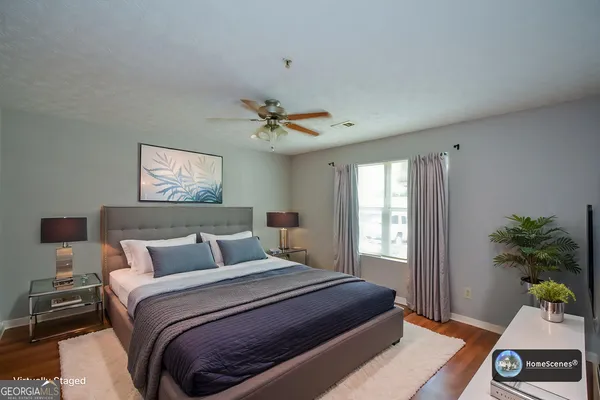 a bedroom with a bed and a potted plant