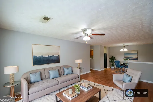 a living room with furniture and a chandelier