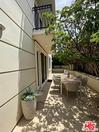 a backyard of a house with yard and outdoor seating