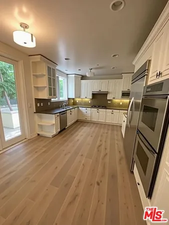a view of a kitchen with microwave and cabinets