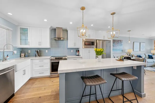 a kitchen with stainless steel appliances kitchen island granite countertop a sink and cabinets