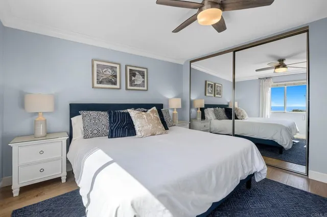 a bedroom with bed and a chandelier