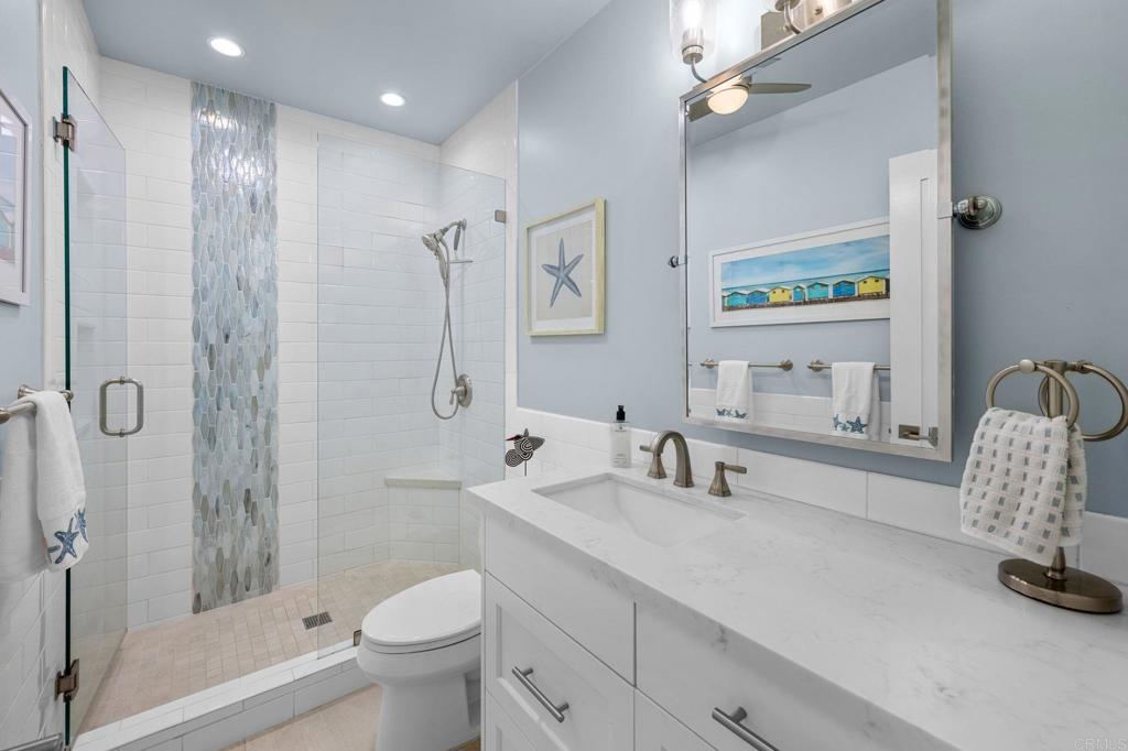 908 Caminito Madrigal, Unit D Carlsbad, CA 92011 - Photo 15 of 23 a bathroom with a sink a toilet and shower