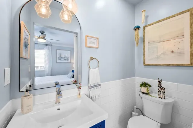 a bathroom with a sink a toilet and a mirror