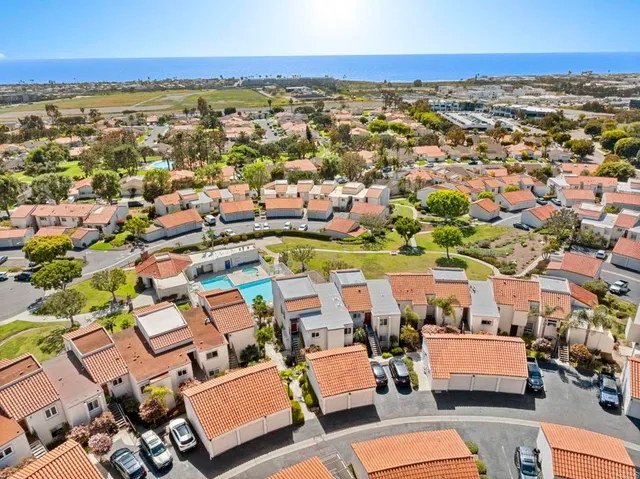 an aerial view of residential houses with outdoor space