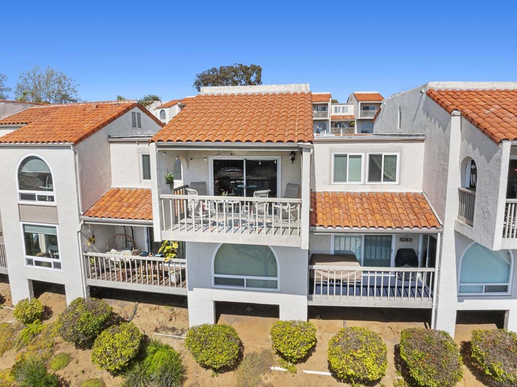 908 Caminito Madrigal, Unit D Carlsbad, CA 92011 - Photo 22 of 23 a front view of a house with a yard