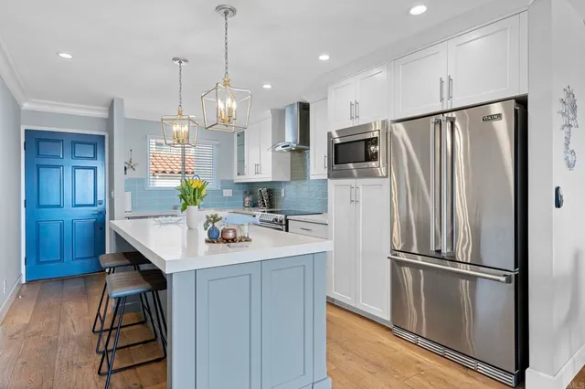 a kitchen with kitchen island a counter top space appliances and cabinets