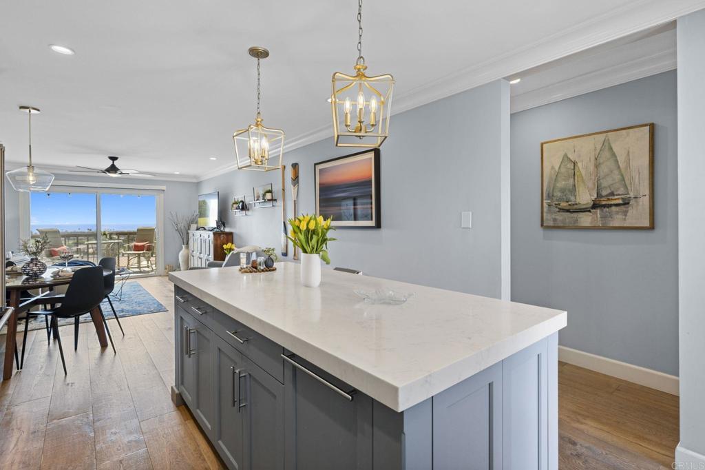 908 Caminito Madrigal, Unit D Carlsbad, CA 92011 - Photo 5 of 23 a kitchen with a table and chairs