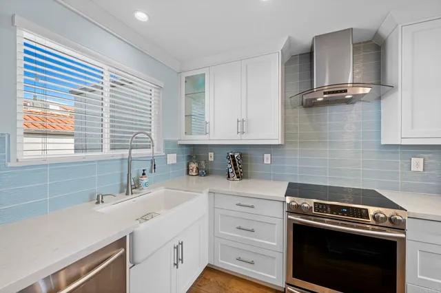 a kitchen with a sink stove and cabinets