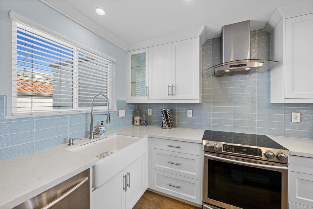 908 Caminito Madrigal, Unit D Carlsbad, CA 92011 - Photo 6 of 23 a kitchen with a sink stove and cabinets